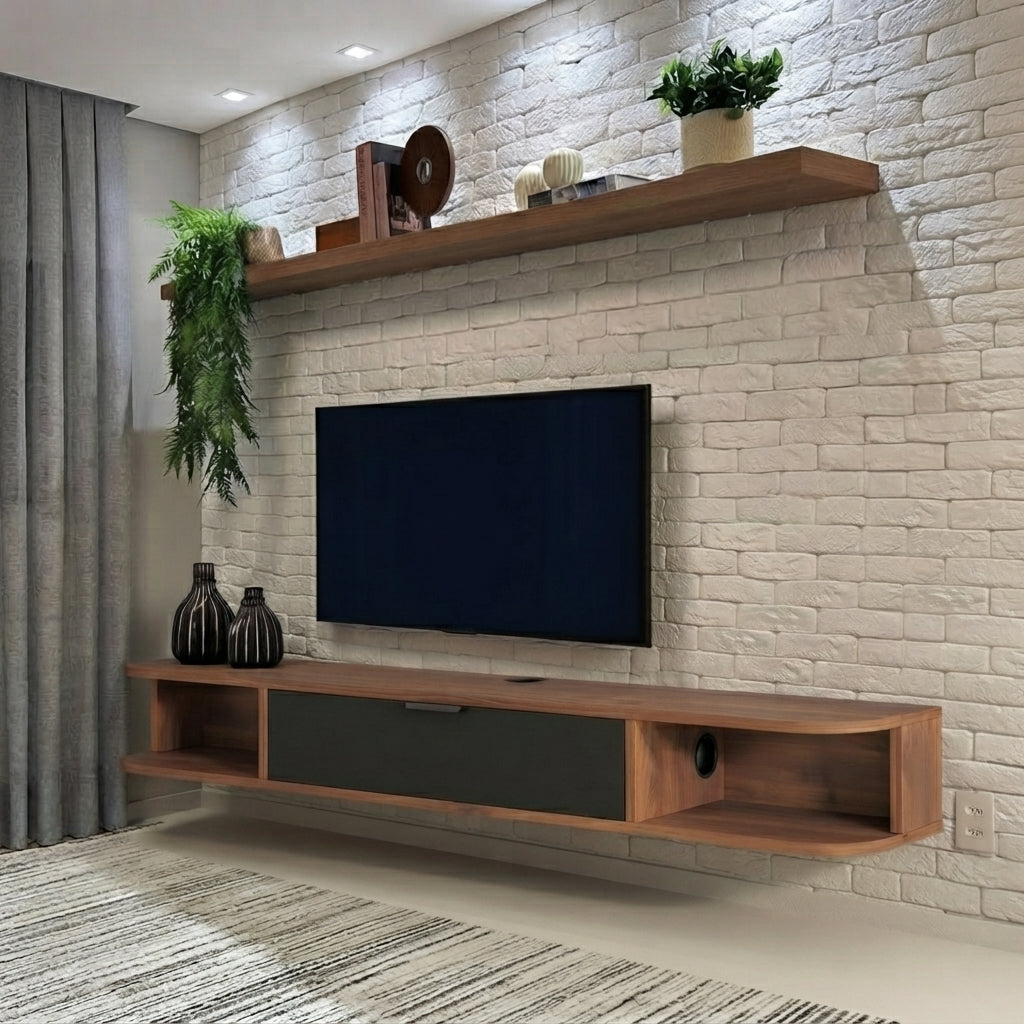 A modern floating TV stand and shelf set in a living room, featuring a medium brown wood finish with a dark gray center drawer, mounted against a white brick wall.