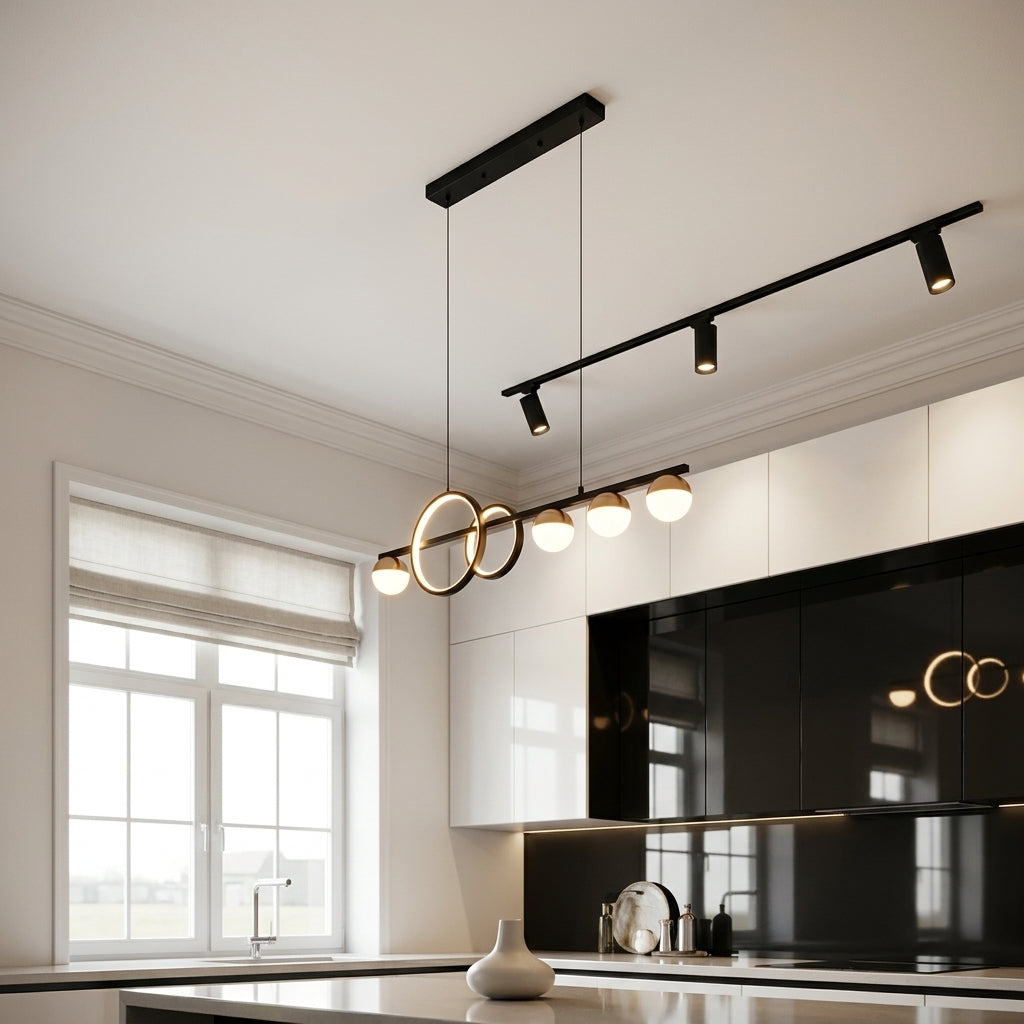 Modern black linear ceiling track lights with multiple adjustable spotlights and two interlocking circular pendant lights, shown installed in a contemporary kitchen with white and black cabinets.