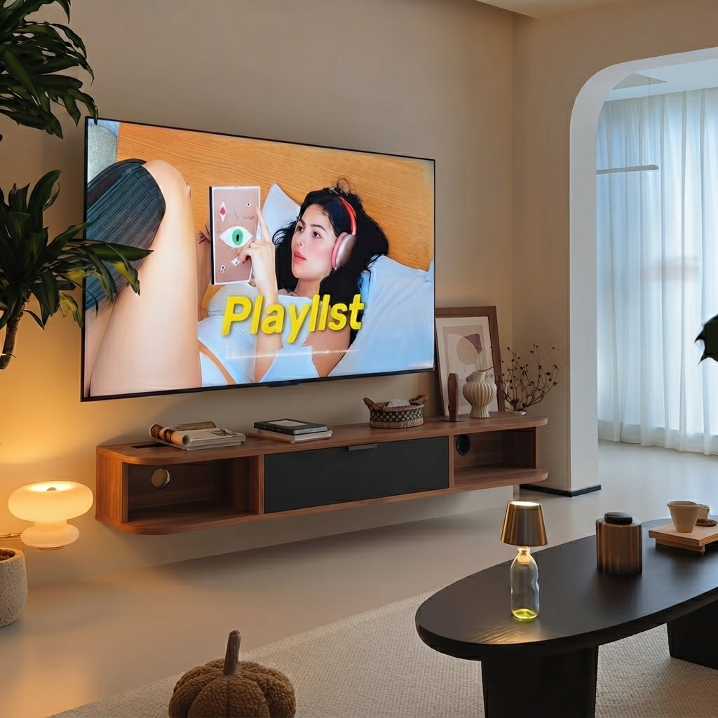 A large wall-mounted flat-screen TV displaying a music playlist cover, mounted above a floating wooden media console in a modern, warm-toned living room.
