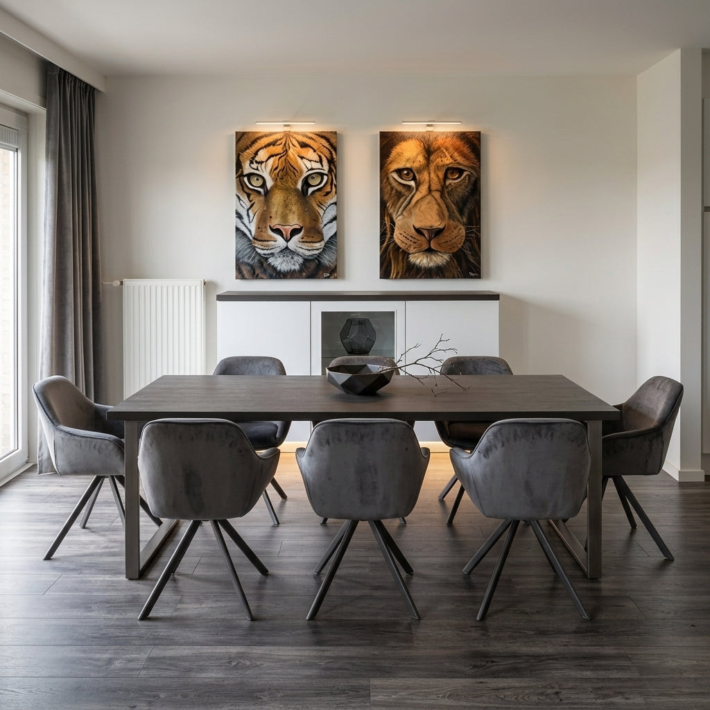 A modern dining room with a dark wood table and gray chairs, featuring two large wall art prints above a white cabinet: a tiger portrait on the left and a lion portrait on the right.