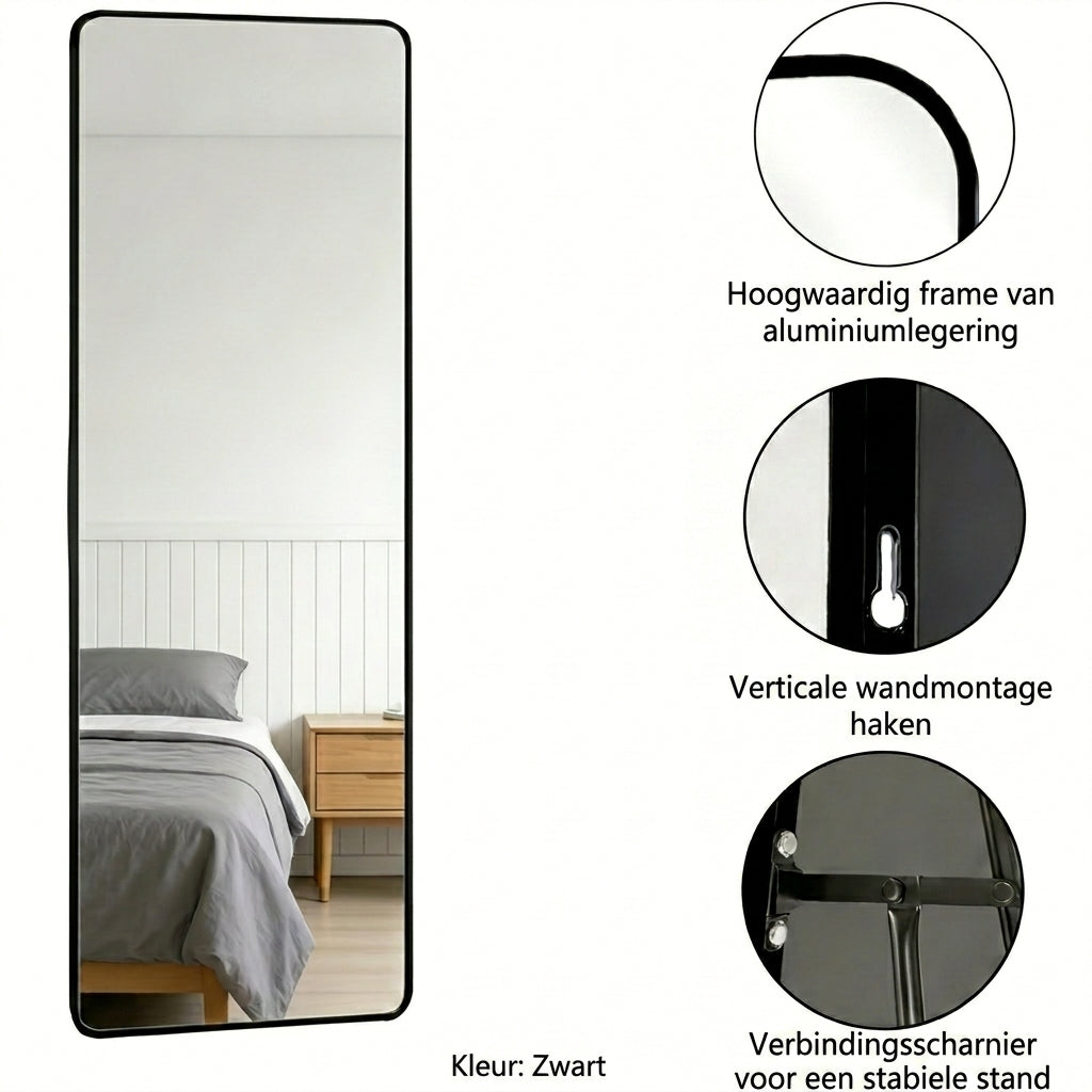 A tall black-framed wall mirror shown on a white background with three circular detail callouts and Dutch text describing frame material, wall mounting hooks, and hinge stability. The mirror reflects a bedroom scene, but the product being sold is the mirror itself.