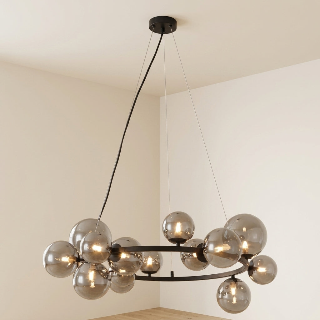 A modern multi-light chandelier with spherical smoked glass globes and a black metal frame, suspended from a ceiling in a minimalist room.