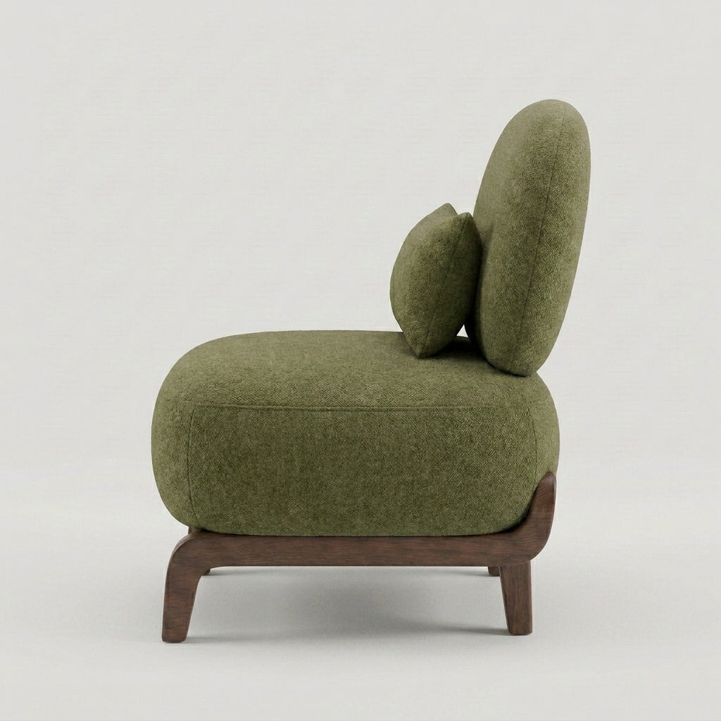 An olive green upholstered accent chair with a curved backrest, matching cushion, and dark wood legs, shown from a side angle against a light gray background.