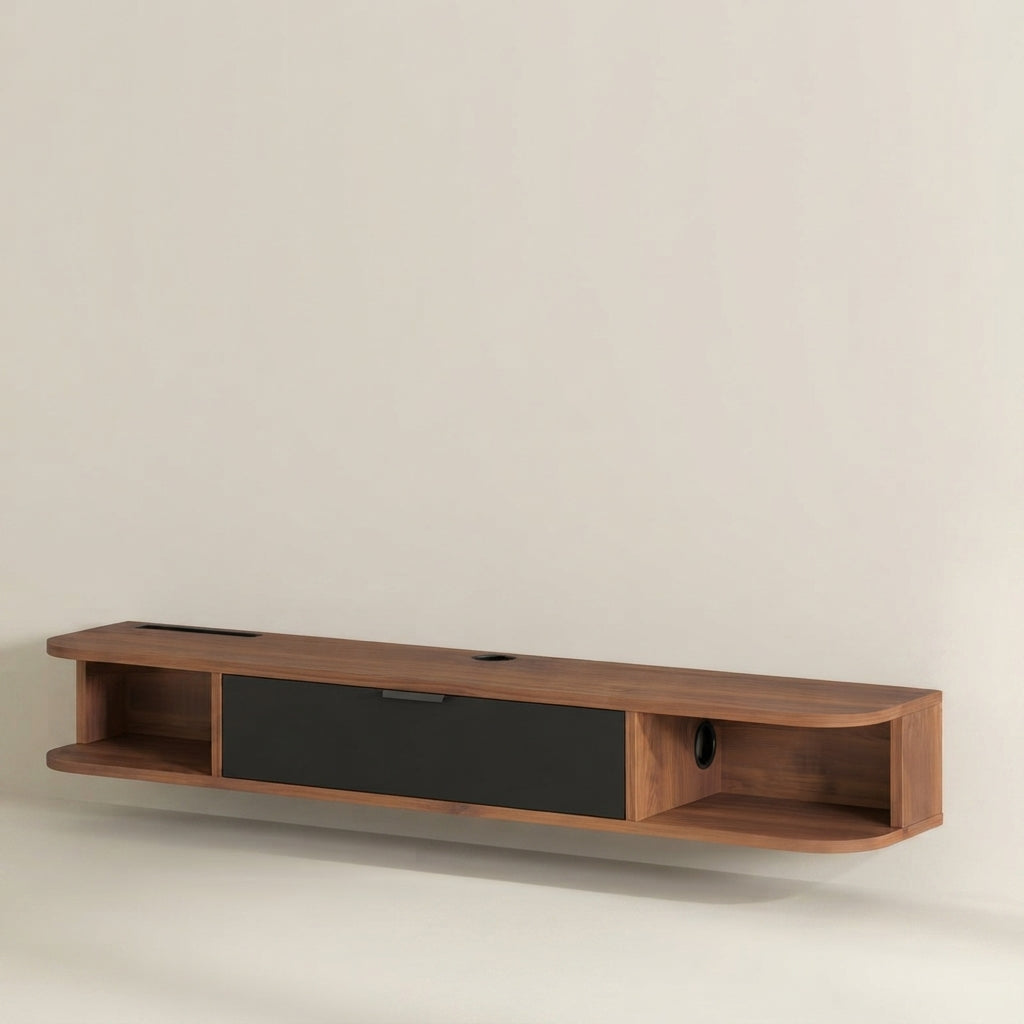 A modern floating wall-mounted media console in warm walnut wood with a central black drawer, shown against a plain off-white wall.