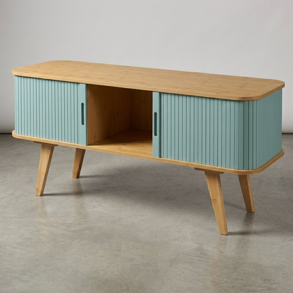 A mid-century modern sideboard cabinet with a light natural wood top and legs, and ribbed turquoise blue doors, shown on a concrete floor against a neutral gray wall.